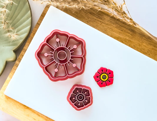 Traditional flowertattoo style clay cutter with cut out sample on a white tile