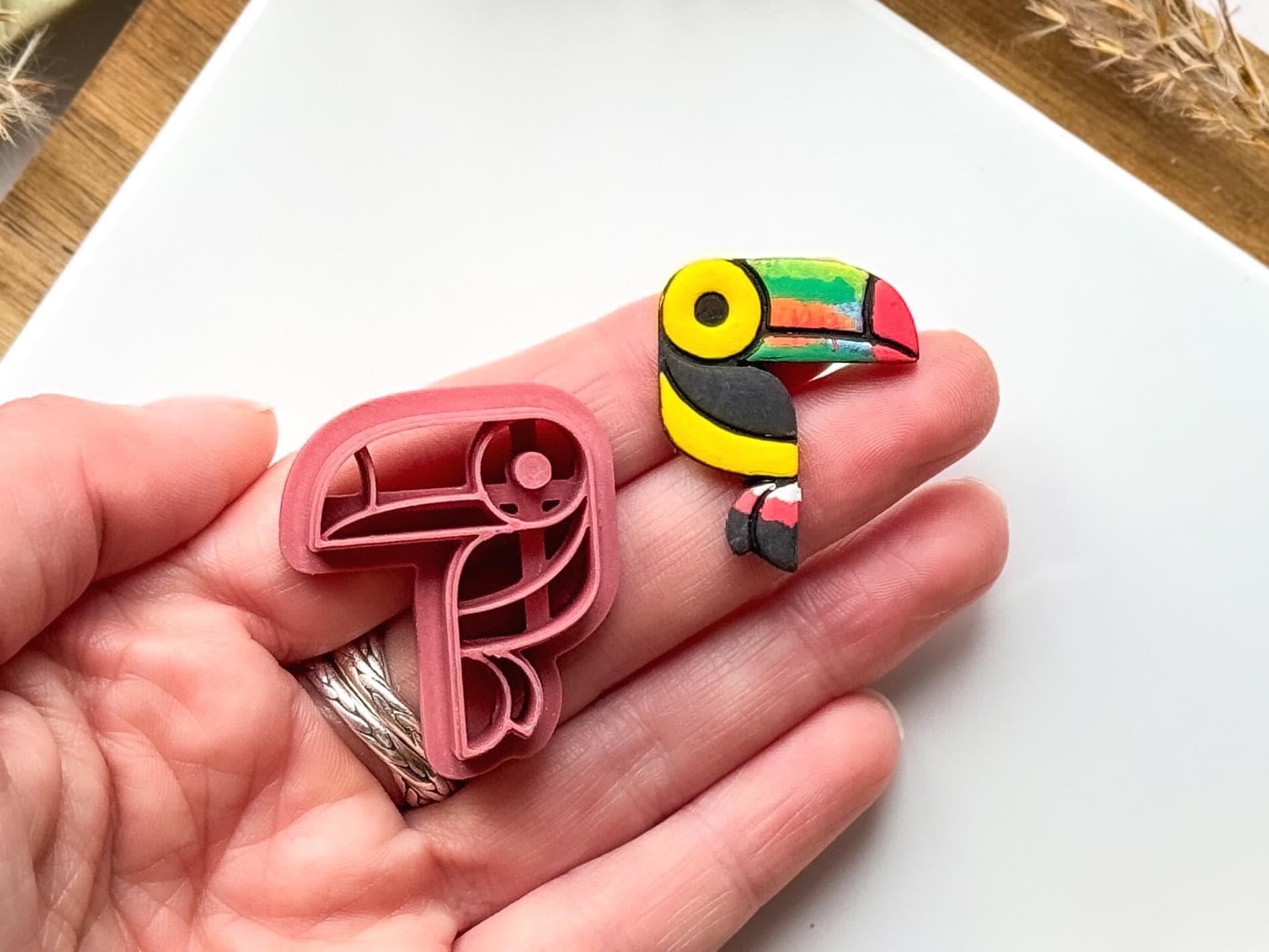 tropical jungle bird clay cutter and colourful cut out clay sample being held in hand