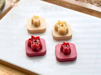 Pink and beige narcissus flower polymer clay tiny cutters on white baking tile
