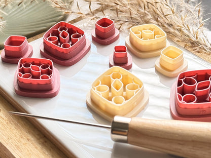 Side view showing the imprint stamp line depth on this rounded diamond shaped cutter for making polymer clay earrings. Several sizes can be seen here, in bothbeige and pink materials.