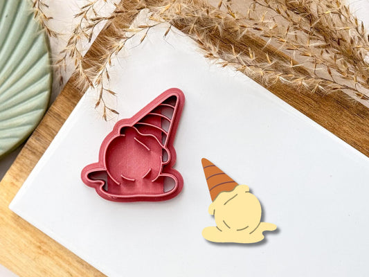 Melting ice cream shaped 3d  printed clay cutter in dark pink. Cutter includes stamp details for the cone and the ice cream