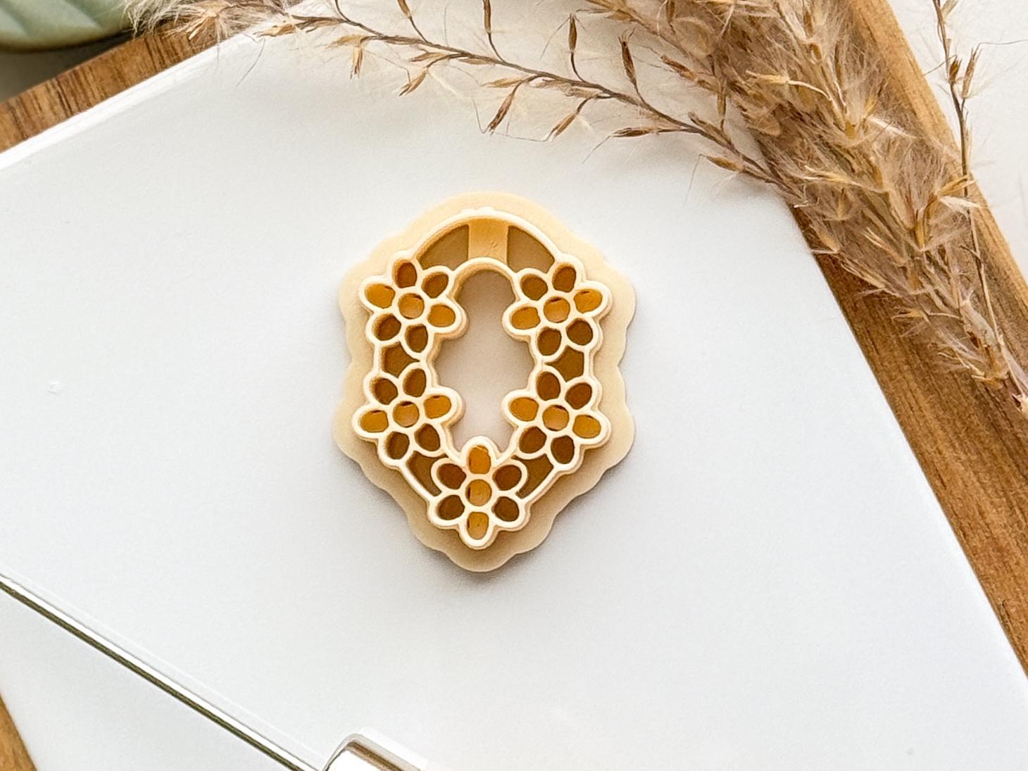 Beige flower clay cutter with oval frame