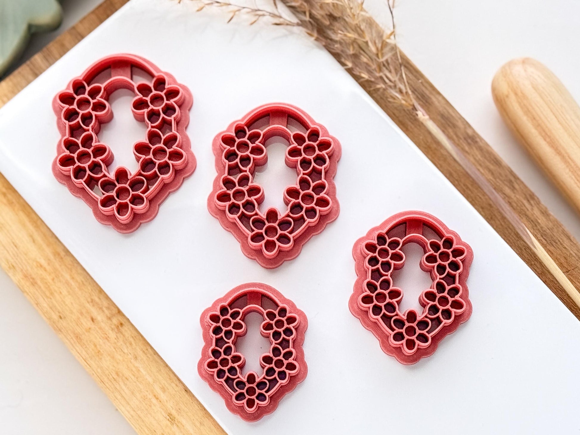 Various sizes of Daisy  flower oval polymer clay cutter on a white tile