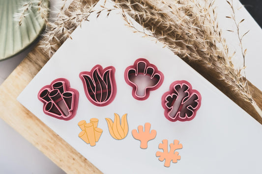 Coral reef polymer clay cutter set featuring tube coral, wavy seaweed, cactus seaweed and traditional coral shapes. 2 outline cutters and 2 imprint cutters