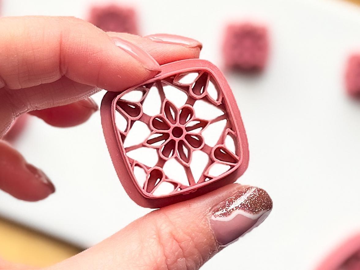 Close up images of the larger square section of this floral clay cutter for jewellery making. Stamp line details are shown clearly.