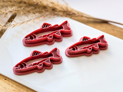 Tilted view of fish clay earring cutter to show depth of stamp lines.