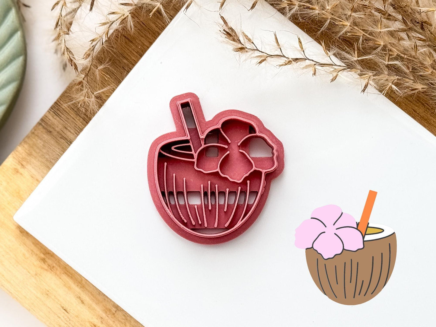 Tropical cocktail shaped clay cutter in dark pink. Coconut shaped cutter with detail lines, flower and drinking straw details.