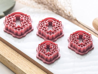 Side view of polymer clay cutters with floral details to show imprint stamp depth