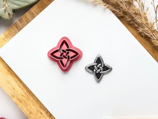 Quaternary celtic knot shaped polymer clay cutter with 4 points and embossed sections.