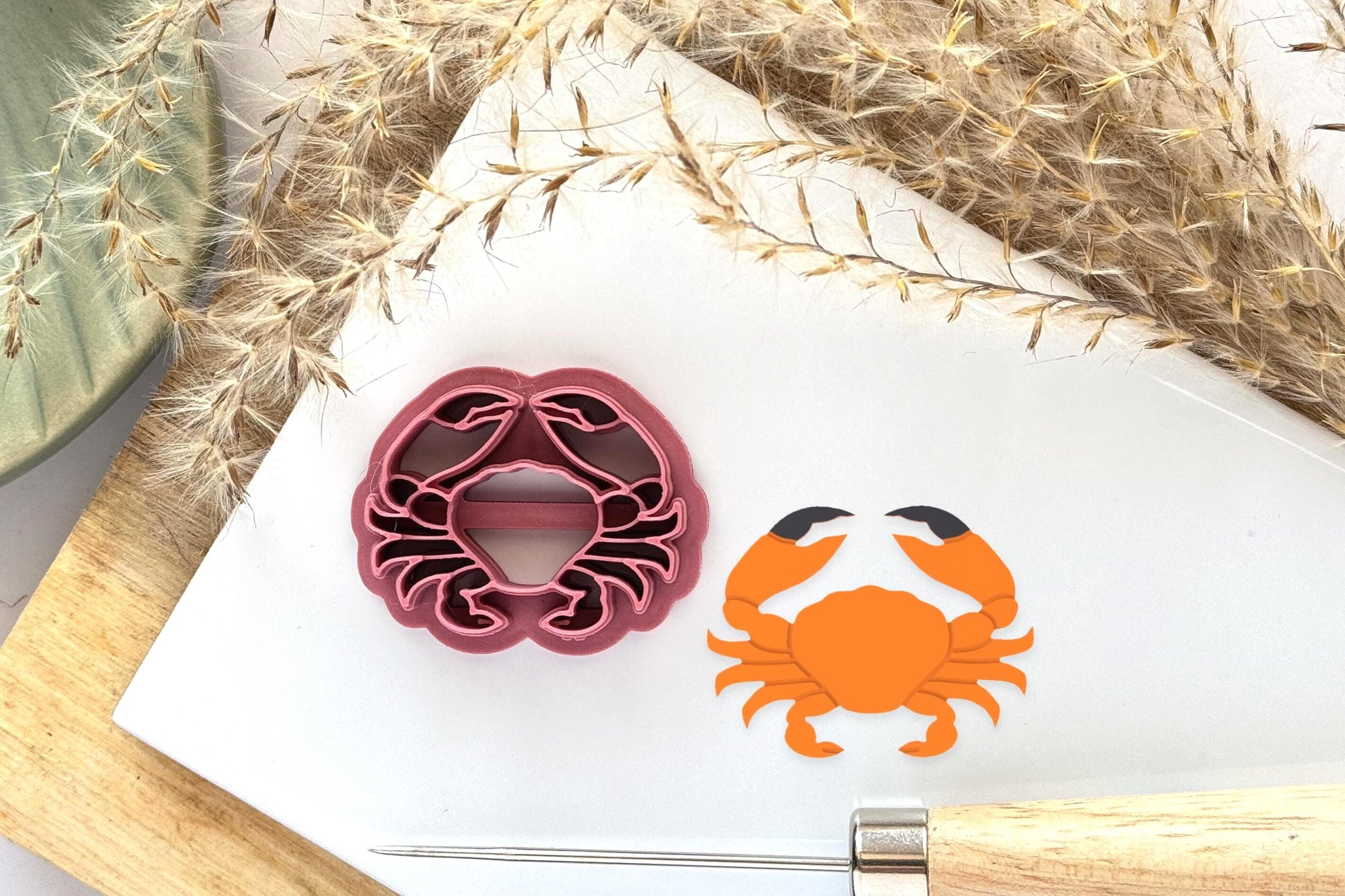 Whole crab polymer clay cutter with legs and large pincers along side a sample using simulated 2.5mm deep clay