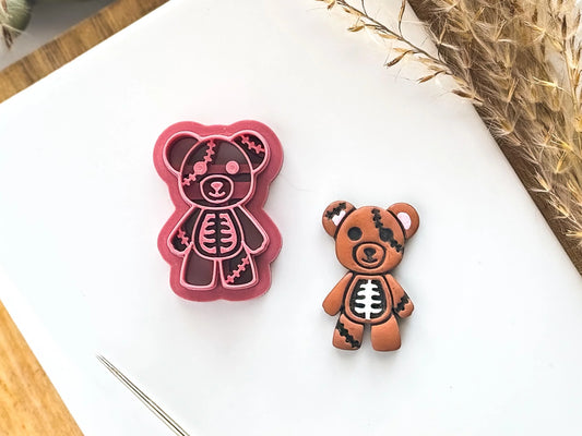 Spooky halloween teddy bear shaped clay cutter with exposed bones and stitches detail