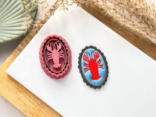 Polymer clay cutter inn a frame style with deep lobster shaped impression in the middle
