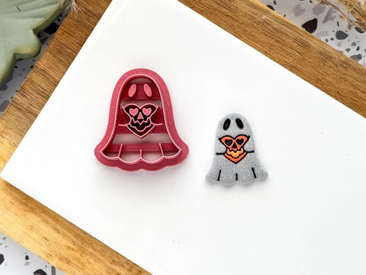 halloween themed ghost shaped clay cutter. Ghost holding a heart shaped pumpkin with polymer clay sample piece