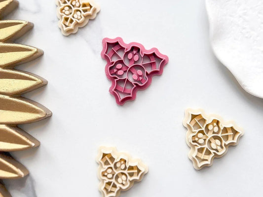 multiple sizes of pink beige and purple Christmas Skull Holly Leaf Clay Cutters for Christmas Crafts.