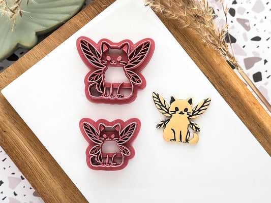 cat shaped clay cutter with fairy winges and polymer clay cut out sample in sand colour