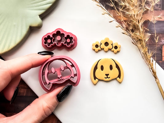 Easter themed lop earred rabbit clay cutter with flower band and cut out plymer clay sample on a white tile