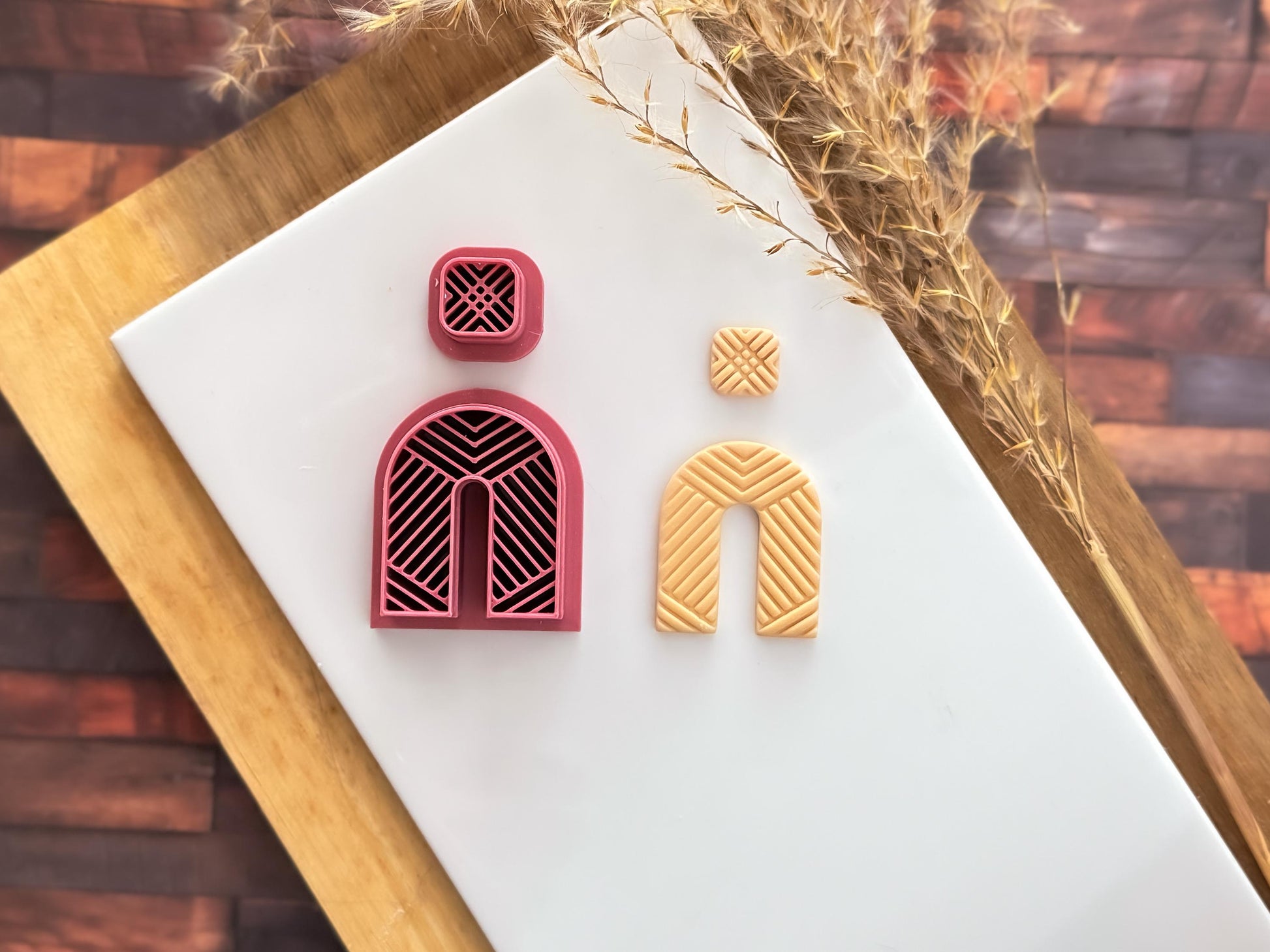 Arch cutter set for making clay earrings, large arch and small square shape with herringbone style impression lines.