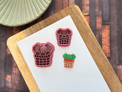 Clay cutter in the shape of a woven basket with 3 carrots inside alongside a polymer clay sample of the cut out and painted piece.