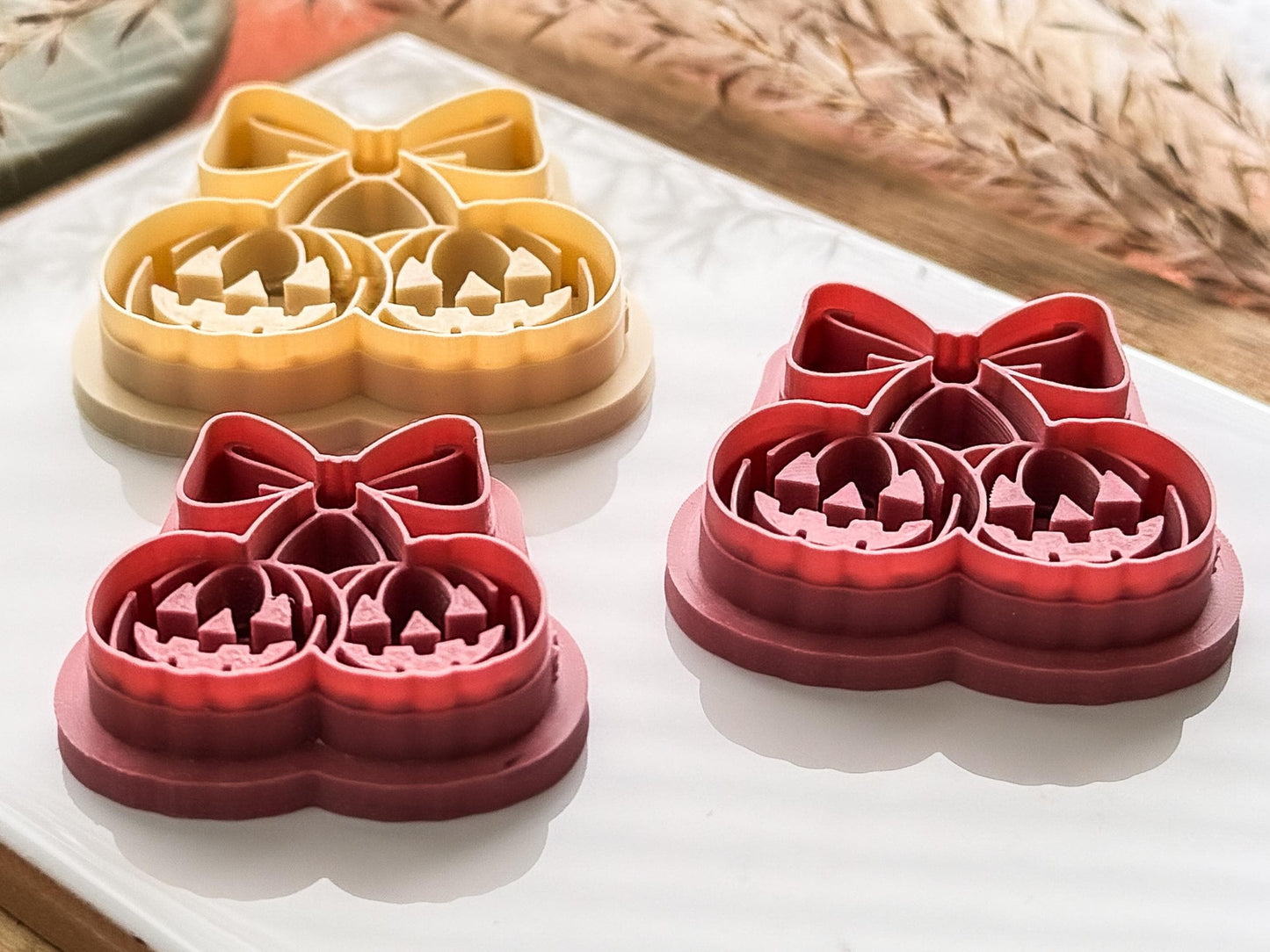Side view of double pumpkin cherry style cutter for polymer clay and fondant. The view shows the sharp cutting edge and the depth of the debossing details.