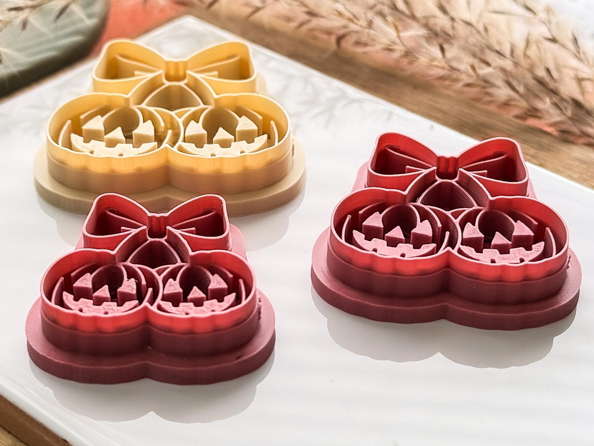 Side view of double pumpkin cherry style cutter for polymer clay and fondant. The view shows the sharp cutting edge and the depth of the debossing details.
