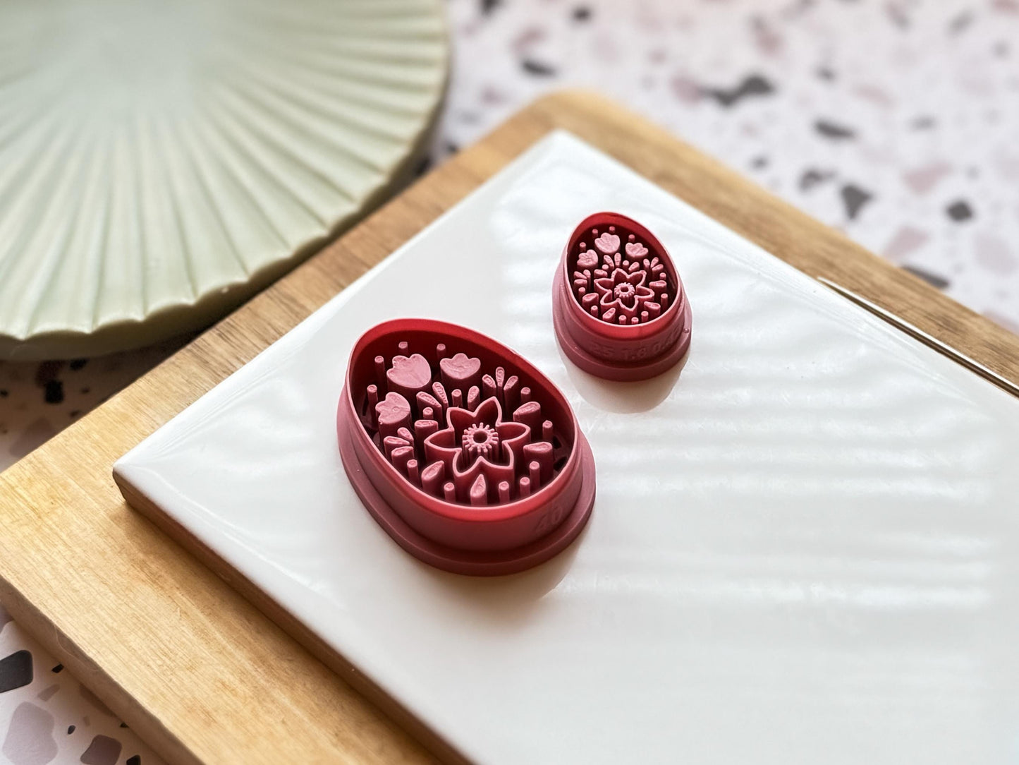 side view of small and large egg shaped boho themed cutter to show clay stamp depth