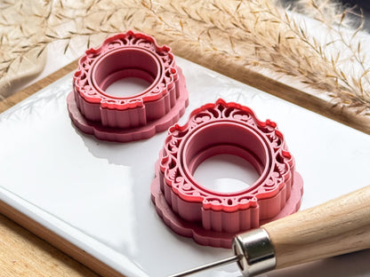 side view of vintage frame clay cutter with ornate swirls and sharp cutting edge