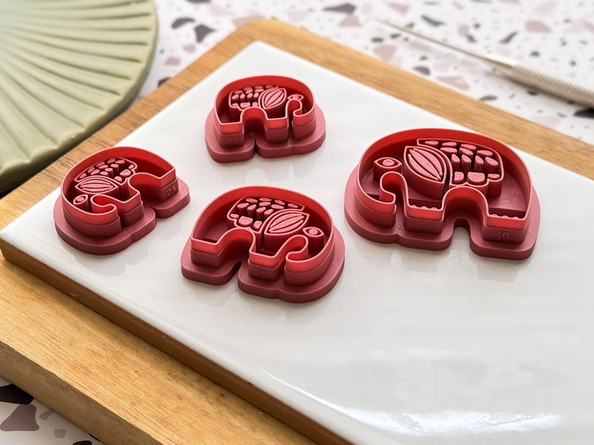 Side view of elephant polymer clay cutters showing the stamp imprint depth a thin cutting wall.