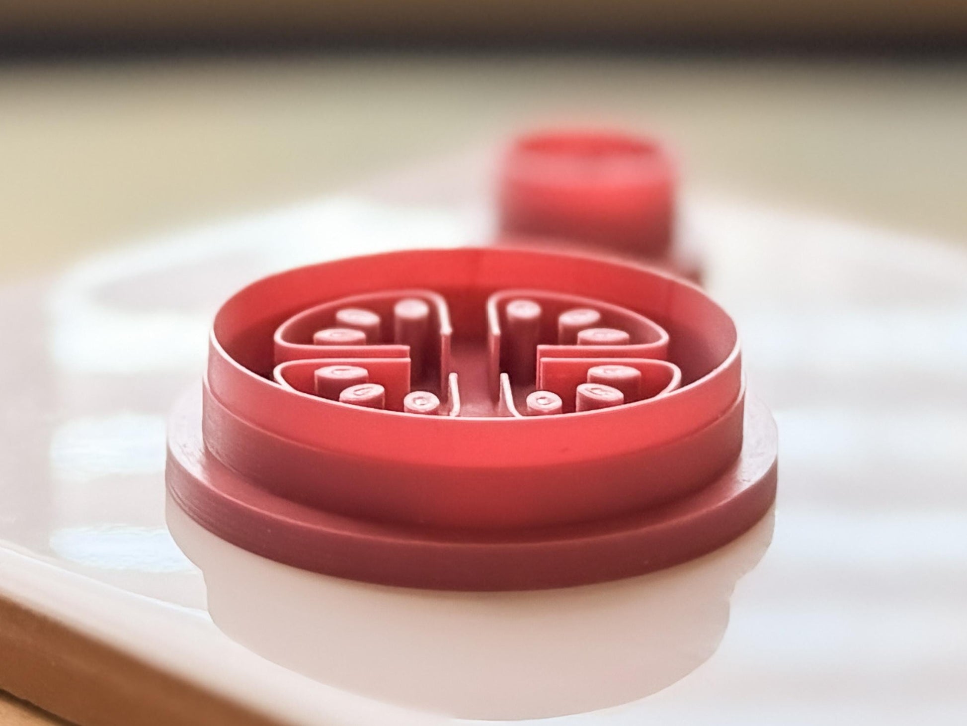 Side view of tomato clay cutter displaying seed stamp height and sharp cutting edge