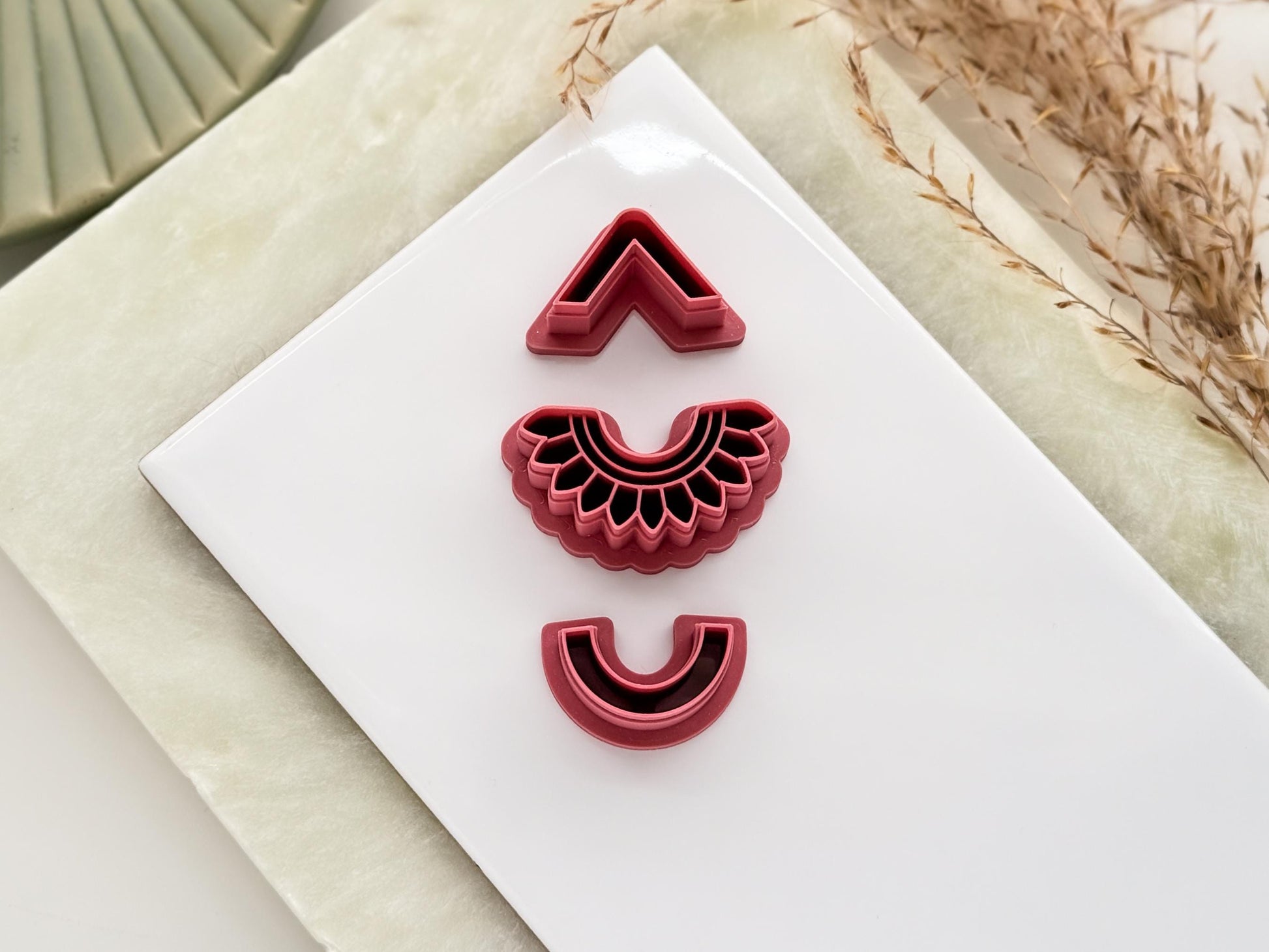 Set of 3 polymer clay earring cutters in geometric shapes with imprint details.