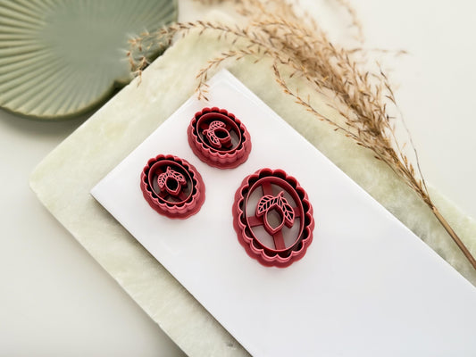 Vintage style lemon frame shaped clay cutters with scalloped edge, inner oval single lemon and leaves stamp details. Thei mage shows a small mirrored pair of cutters and a single large cutter.