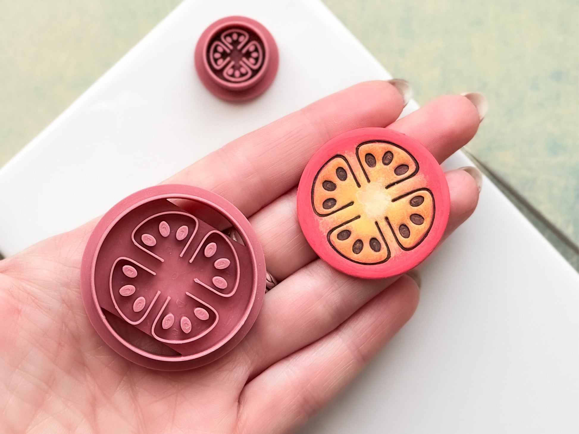 Close up of tomato slice clay cutter and polymer clay cut out sample