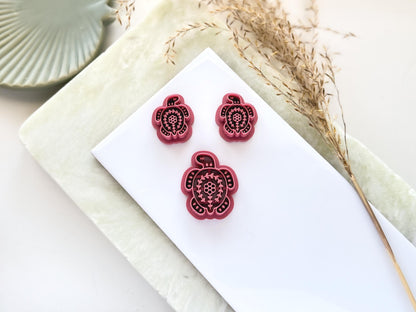 3 turtle shaped clay cutters with folk art style floral imprint patterns. This image features a single large cutter and smaller mirrored pairs for earring and jewellery making