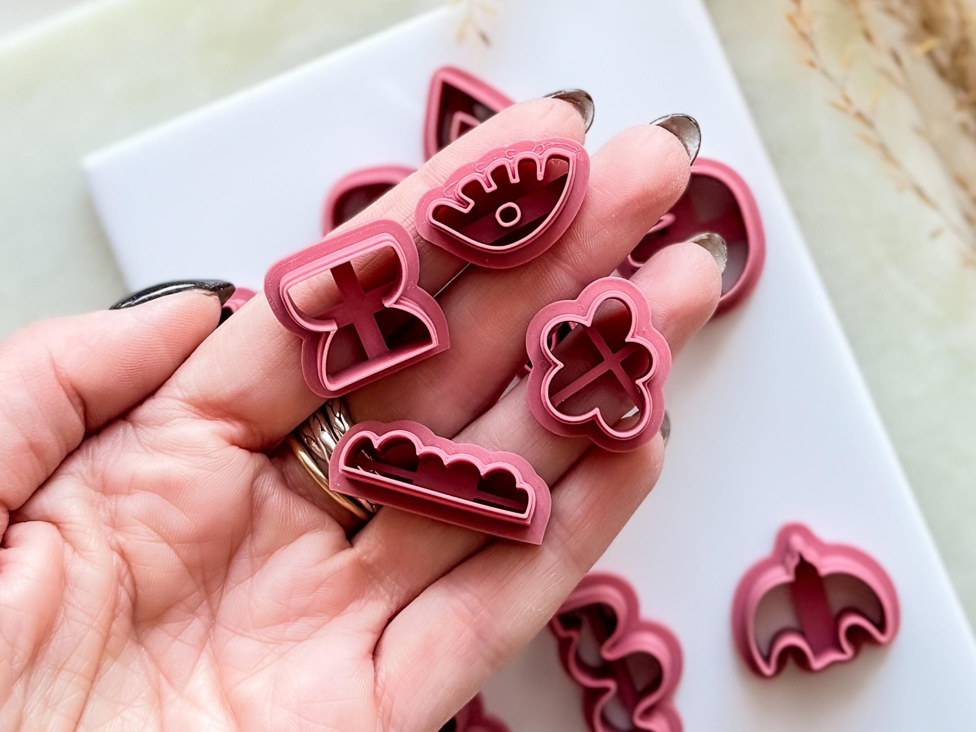 Close up of abstract boho clay cutters being held in a hand