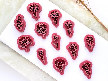flower shaped stamps for polymer clay jewellery making. They are 3D printed in a pink material. There are 12 different flower shapes.