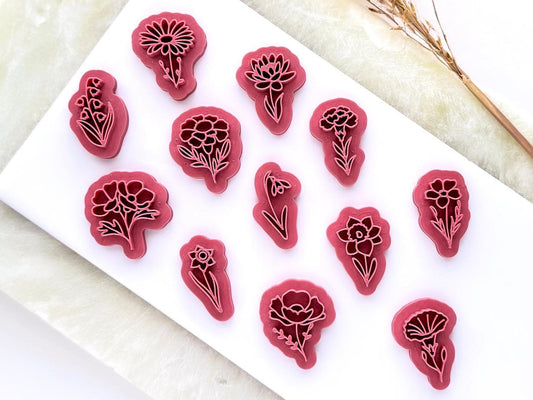 flower shaped stamps for polymer clay jewellery making. They are 3D printed in a pink material. There are 12 different flower shapes.