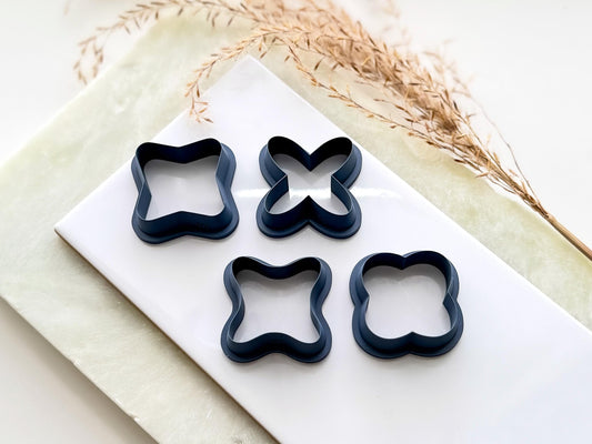 Four cross shaped clay cutters, outline shape only. the cutters feature a bevelled edge and very sharp cutting edge. Each cutter is a different x shape.