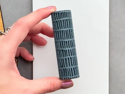 Modern brick pattern texture roller for polymer clay shown in hand to demonstrate scale.