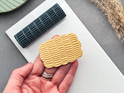Detailed view of modern brick pattern texture roller and polymer clay imprint for jewellery making.