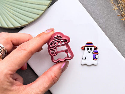 Summer ghost polymer clay cutter held beside a finished ghost earring holding a colourful smoothie drink.