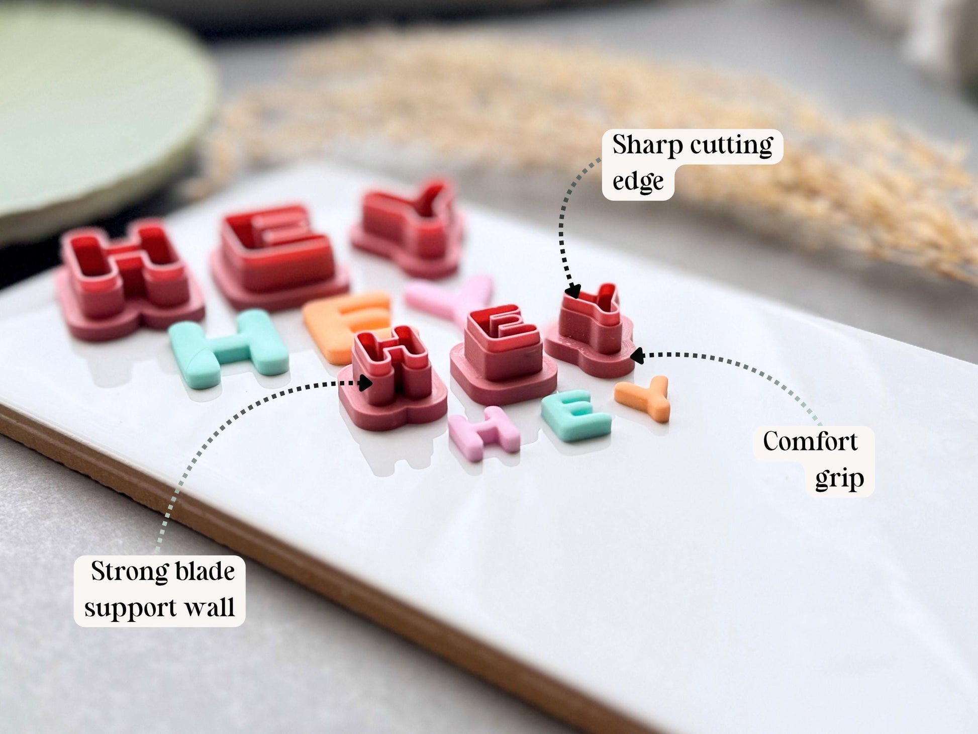 Diagram showing the sharp cutting edge, strong blade support wall and comfort grip of uppercase alphabet polymer clay letter cutters.