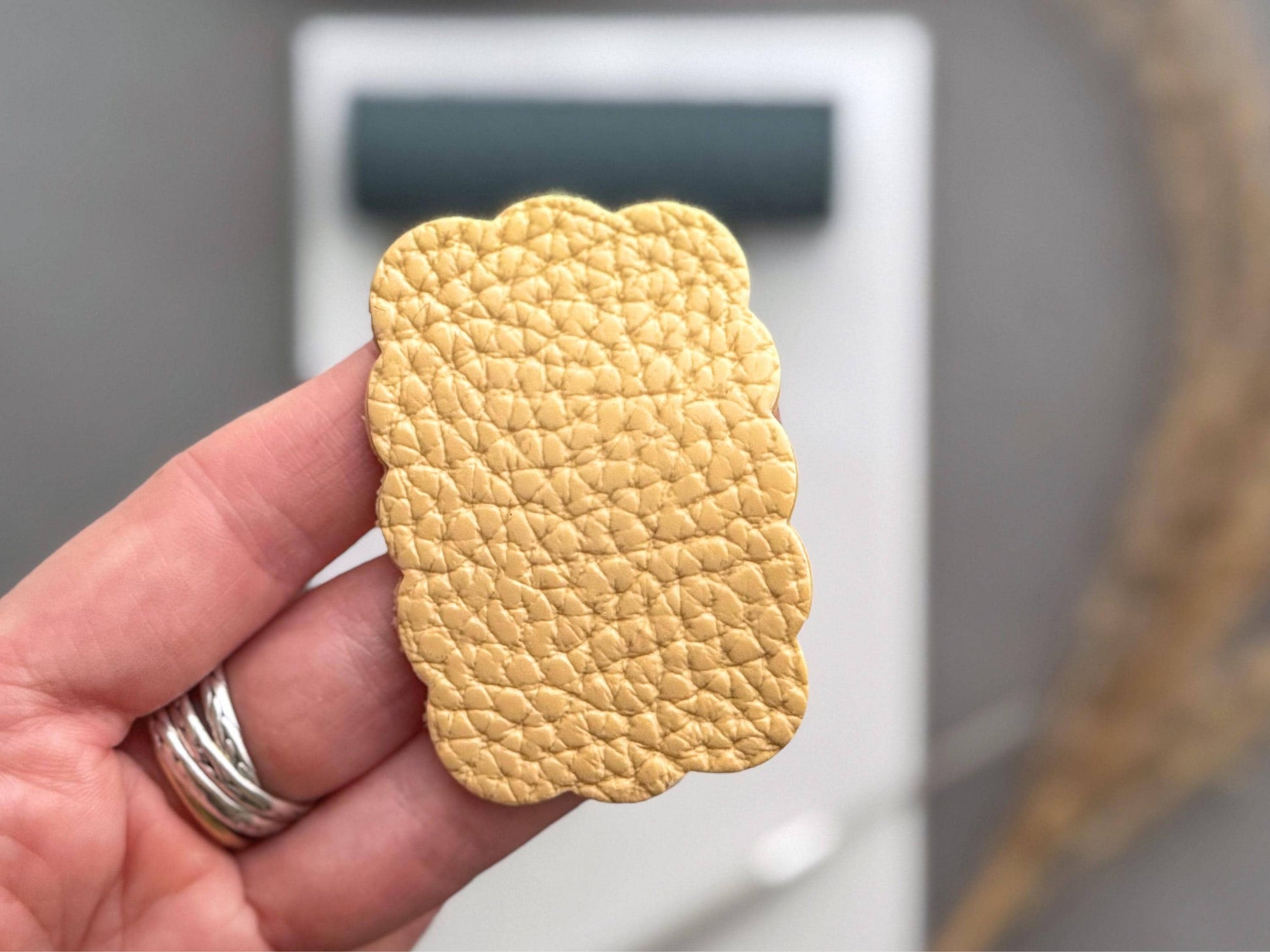 Detailed pebbled leather effect on polymer clay shown in hand to highlight realistic grain texture.