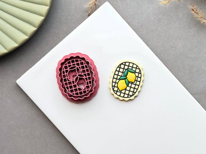 Lemon frame polymer clay cutter displayed beside a matching finished polymer clay embellishment featuring two lemons inside a decorative lattice frame.