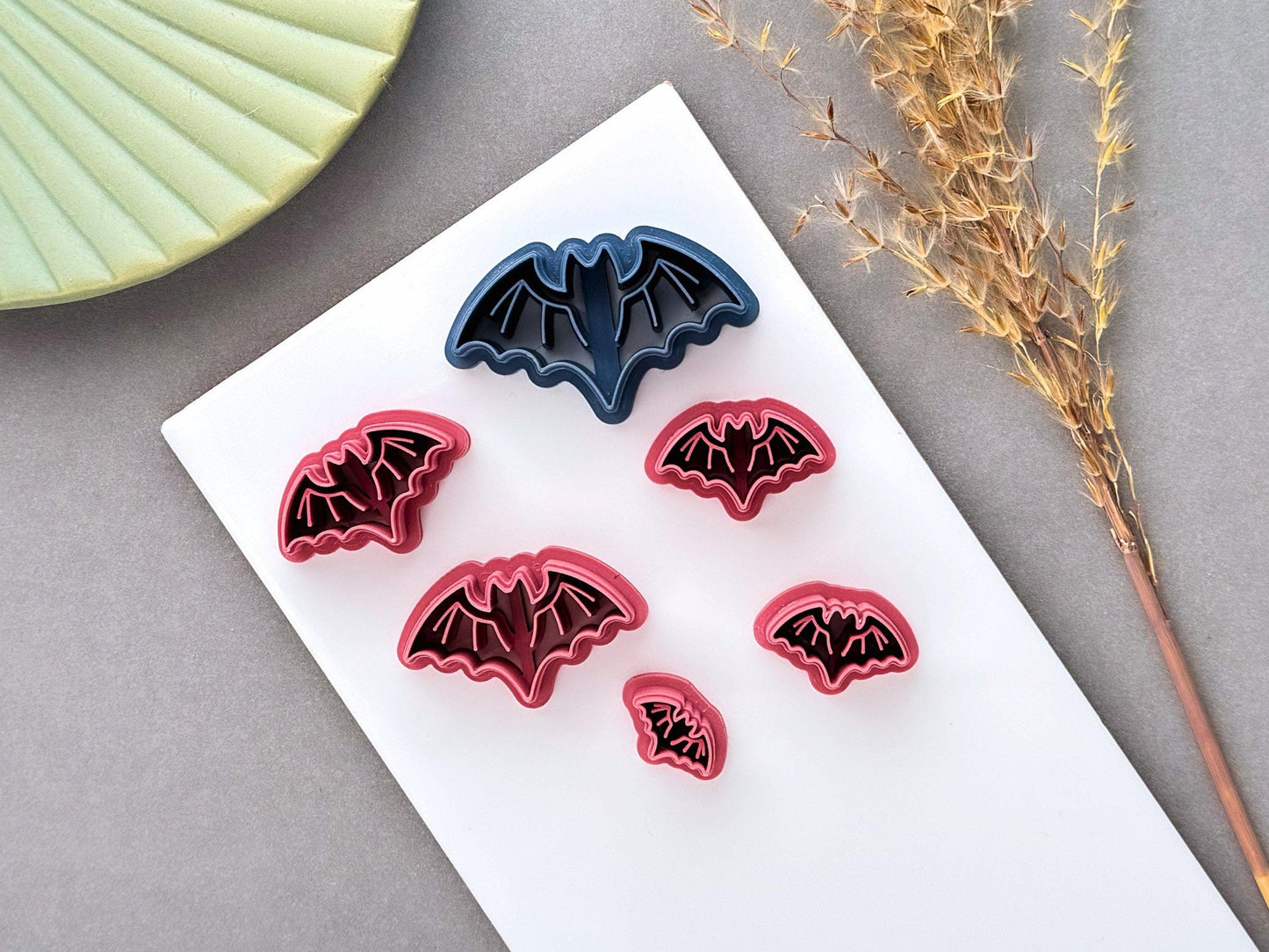 Bat polymer clay cutters displayed in multiple sizes, featuring a simple winged bat design with scalloped wings, perfect for Halloween, gothic and spooky clay projects.