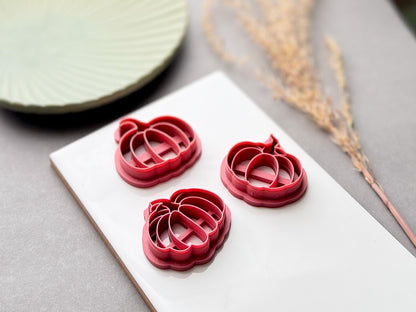 Pumpkin polymer clay cutters in multiple sizes, shown from a low side angle to highlight the cutter depth, sturdy support walls and detailed pumpkin shape.
