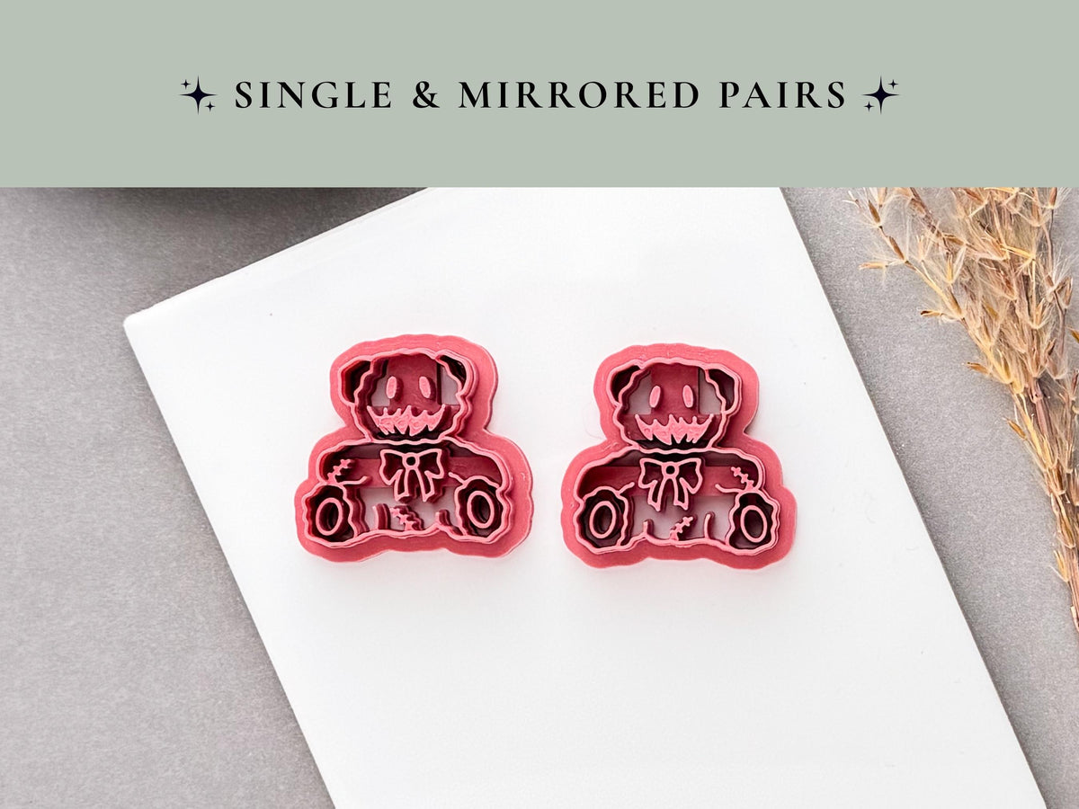Spooky teddy bear polymer clay cutters showing a single and mirrored pair, featuring stitched bear designs with a bow tie, button-like eyes and seam details.