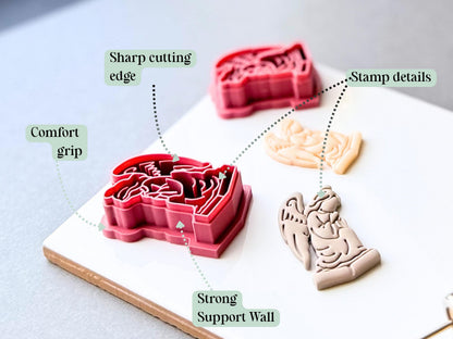 Feature graphic showing a gothic angel clay cutter with detailed kneeling winged angel stamp details, alongside finished polymer clay angel cut-outs. Labels highlight the sharp cutting edge, stamp details, strong support wall and comfortable grip.