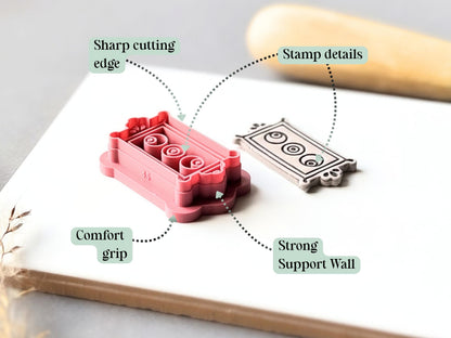 Feature graphic showing the rectangular frame clay cutter with three eyeball details, alongside a finished cream polymer clay cut-out. Labels highlight the sharp cutting edge, detailed stamp design, comfortable grip and strong support wall.
