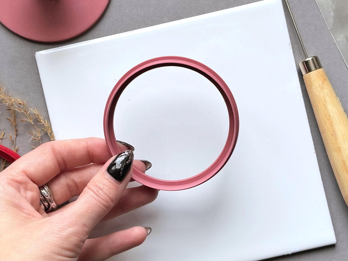 7cm large circular polymer and pottery clay cutter being held in a hand
