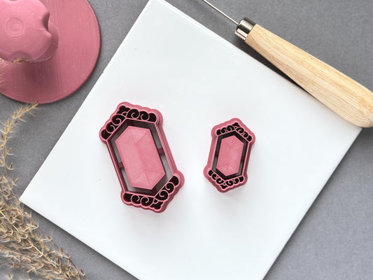 Two vintage-style frame and mirror polymer clay cutters in different sizes, featuring ornate scrollwork borders and a central geometric panel, displayed on a white tile.