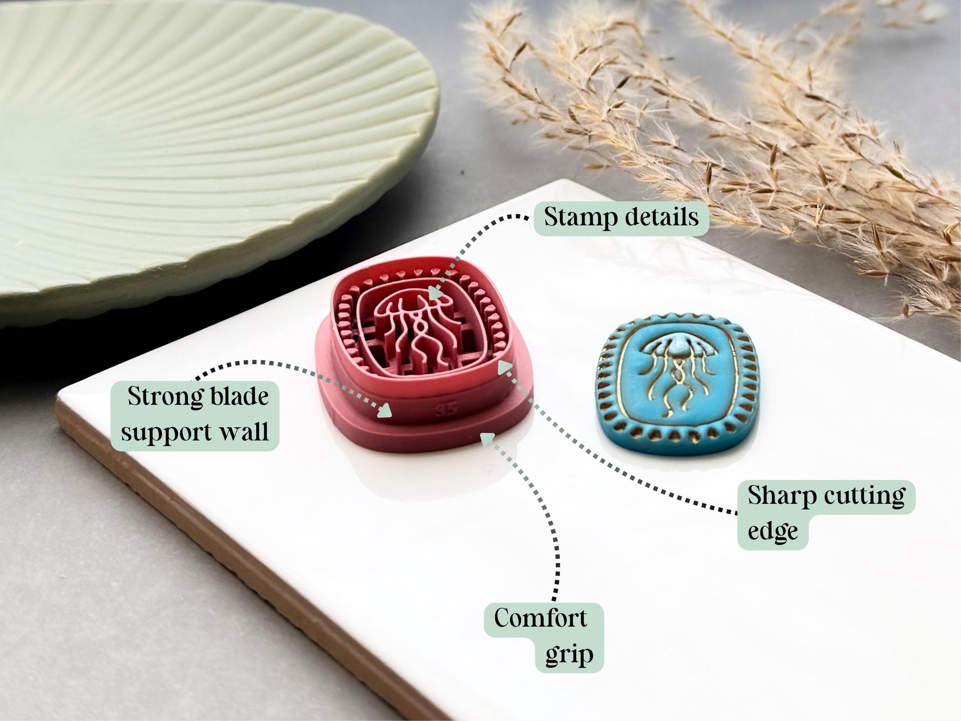 Jellyfish polymer clay cutter highlighting the sharp cutting edge, comfort grip, reinforced support walls and detailed embossed stamp design, displayed alongside a finished polymer clay jellyfish sample.